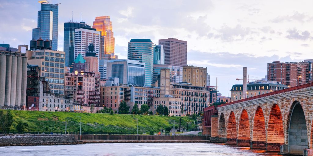 Downtown Minneapolis, Minnesota at night time as seen from the famous stone arch bridge