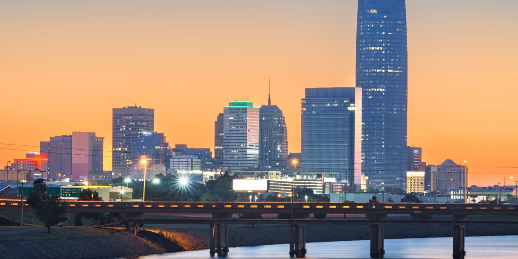 Oklahoma City, Oklahoma, USA downtown skyline on the Oklahoma River at dawn.