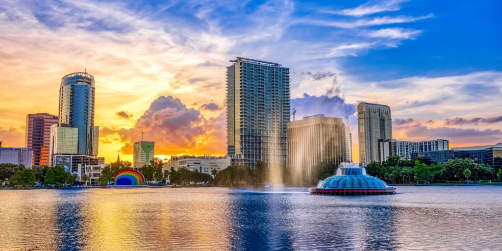 ORLANDO FL, US - May 24, 2022: Sunset and clouds over the Orlando skyline and fountain at Lake Eola Park, Orlando FL